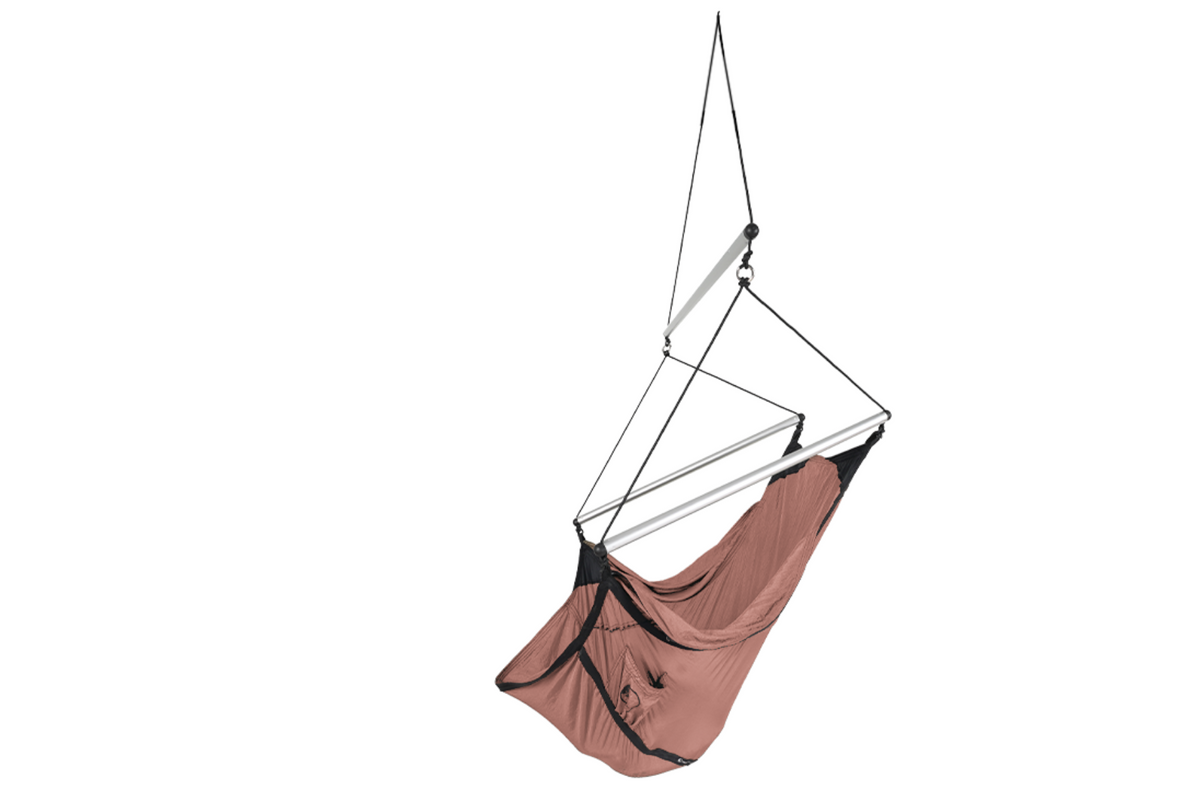 Mini Moon Chair in Peach, hung from a single line with its spreader bars, angled view