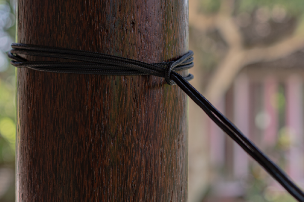 Close-up of a Nautical Ropes (2-Pack) wrapped around a wooden post and tied with a knot