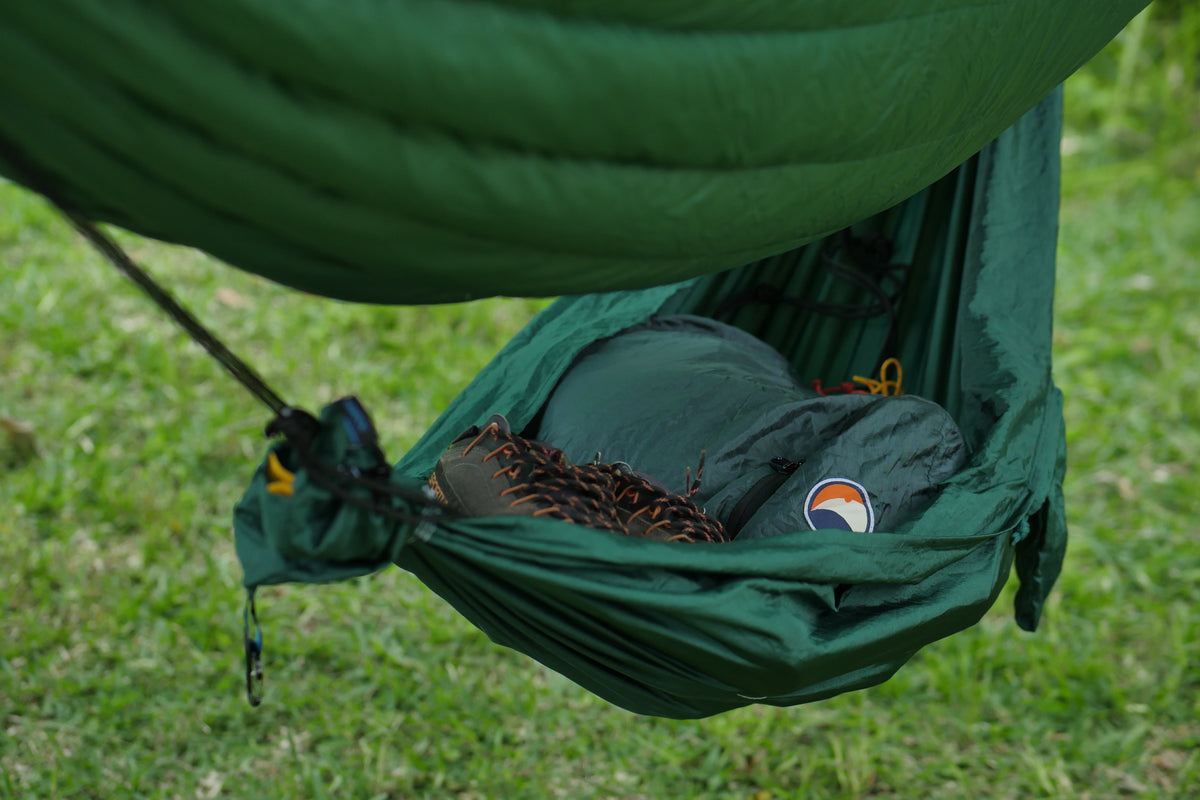 Travel Hammock Mini hung beneath a larger hammock as a gear shelf, holding shoes and stuff sacks