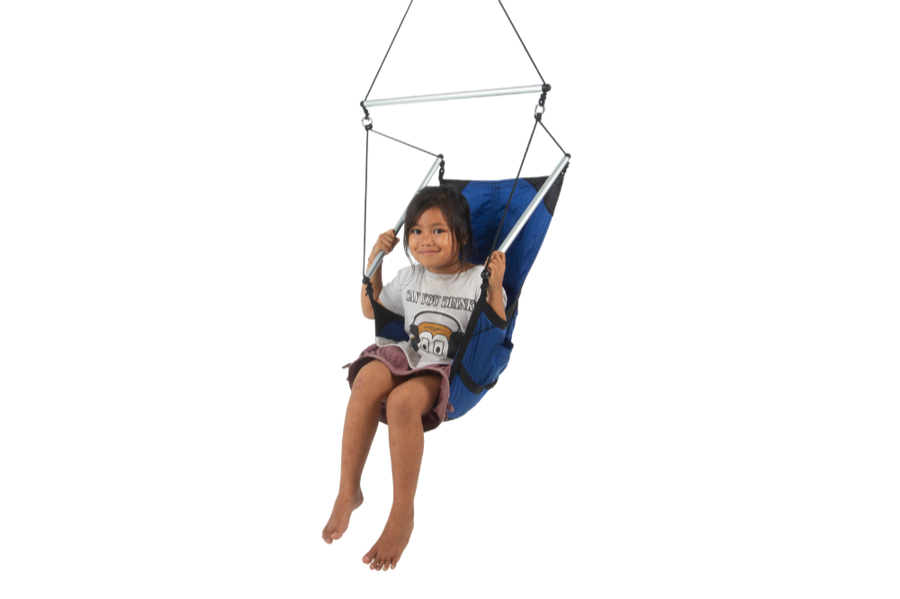 Smiling child sitting in a Mini Moon Chair (Custom) in blue, holding the side bars