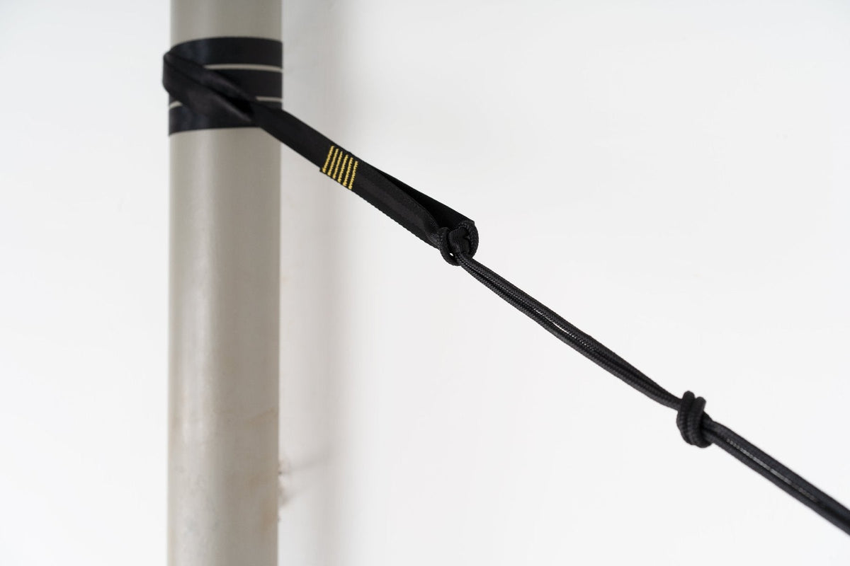 Tree Friendly Extender (2-Pack) looped around a pole with its black whoopie sling knotted to the end loop, close-up