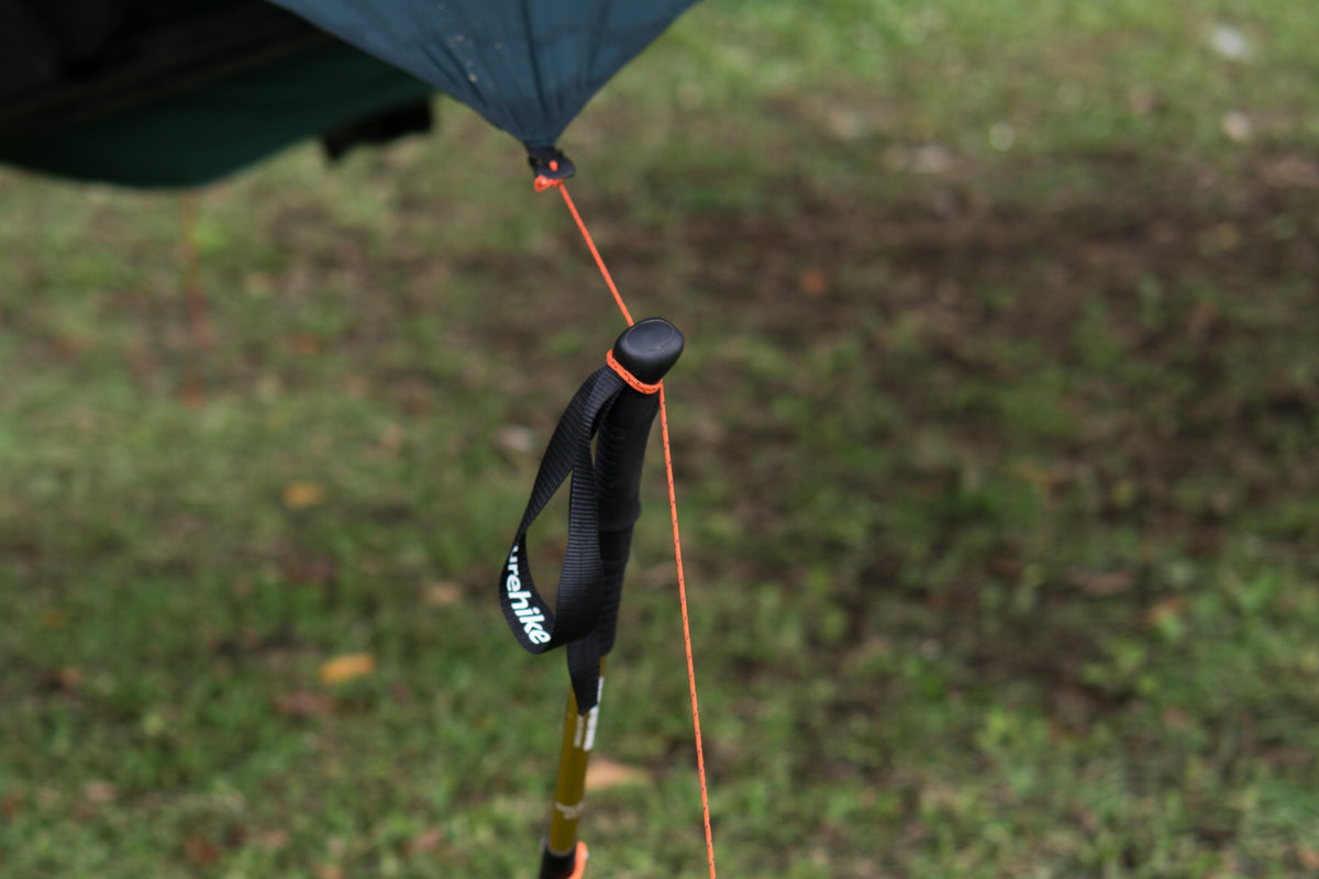 Moon Tarp corner guyline tied to the top of a trekking pole