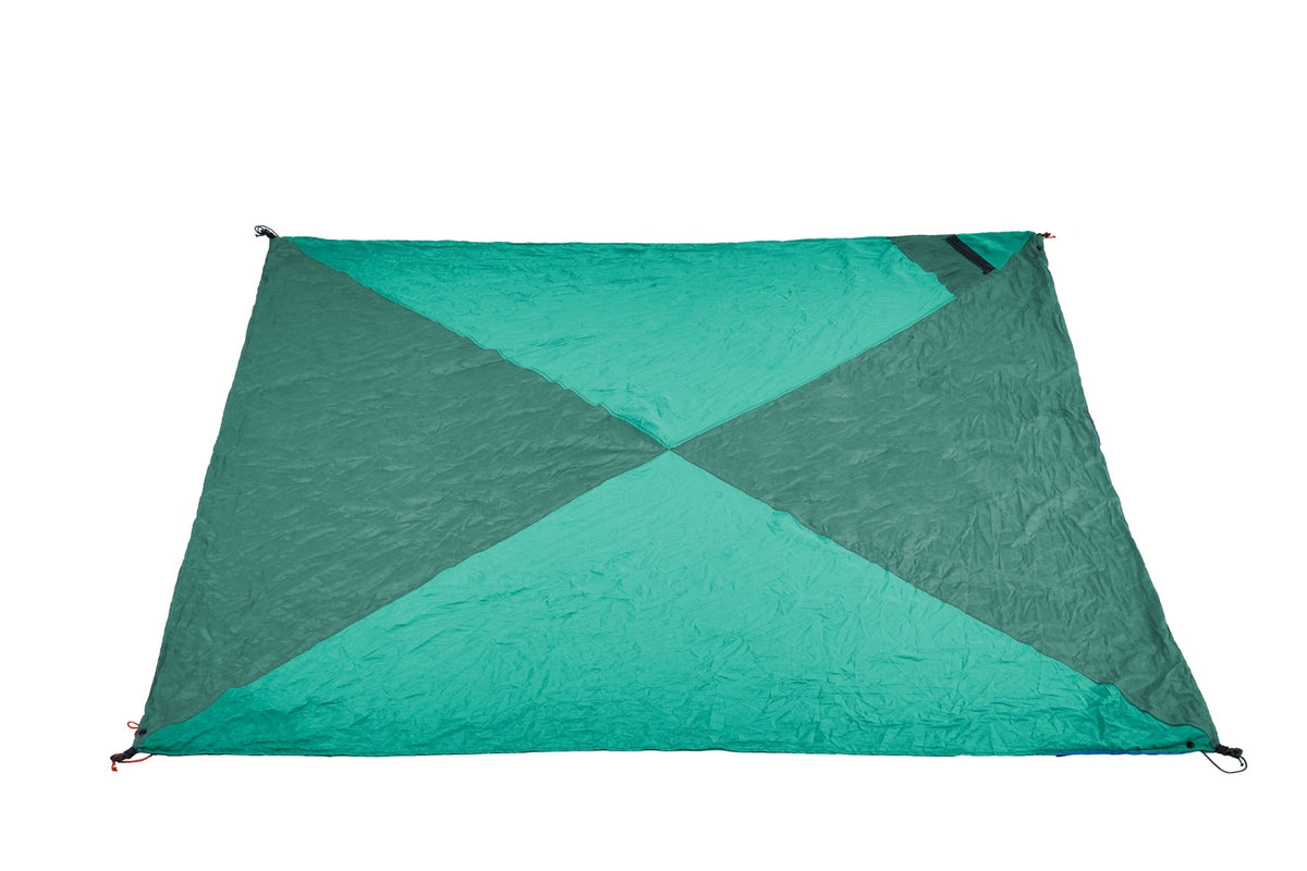 Travel Blanket in dark green and turquoise, laid flat with its four triangular panels