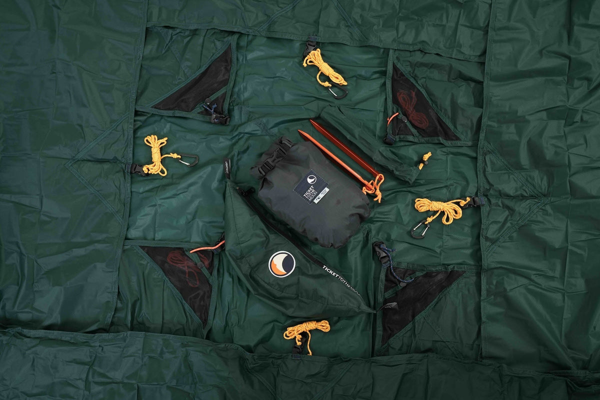 Lightest Tarp laid flat with its stuff sack, stakes and orange guylines