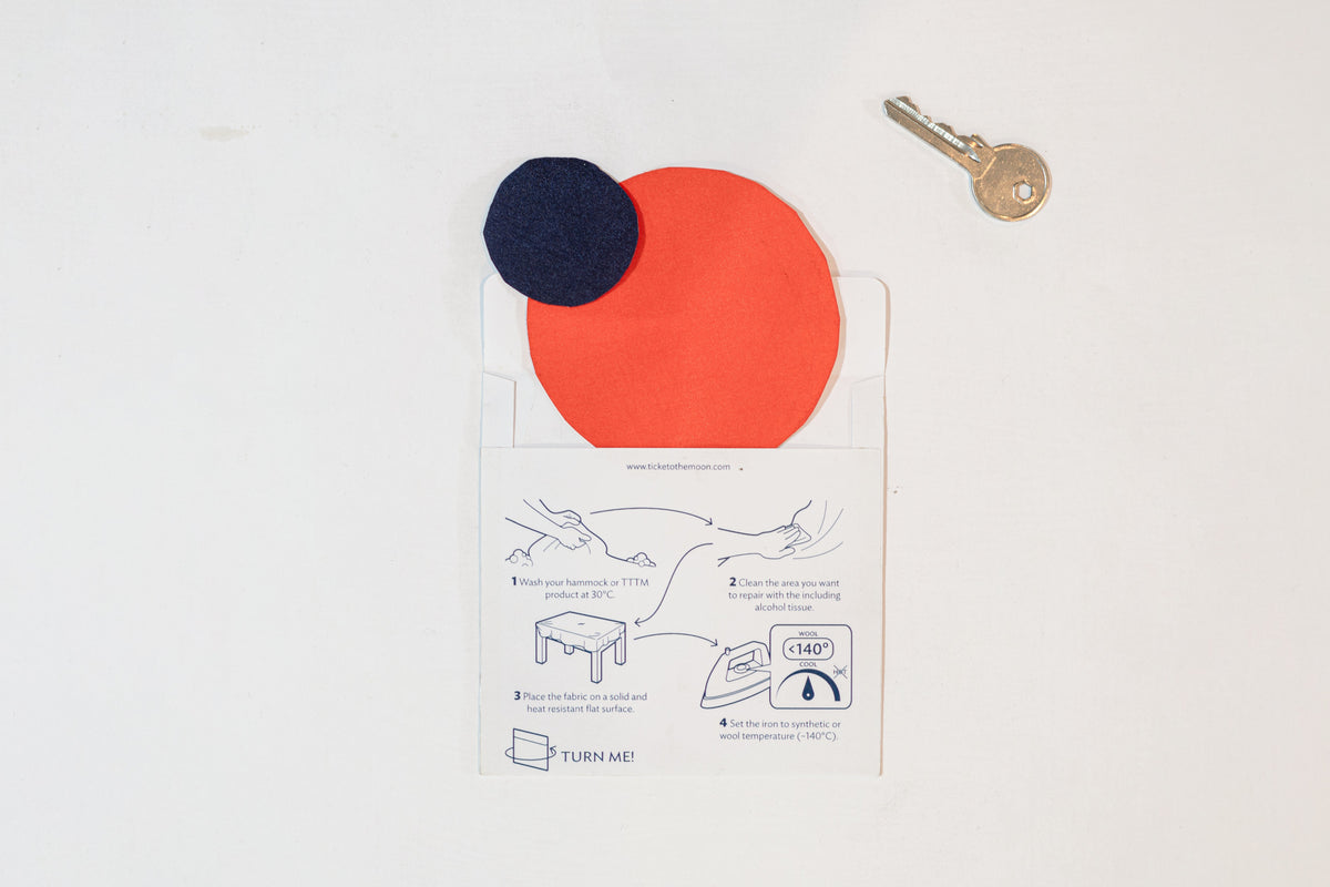 Repair Patch (2-Pack): navy and orange round patches on an envelope with illustrated iron-on instructions, key shown for size