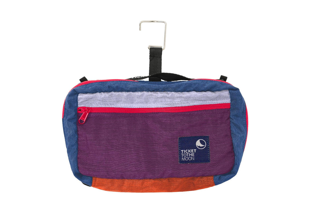 Wash Bag in purple, blue and orange, closed with its metal hanging hook, front view