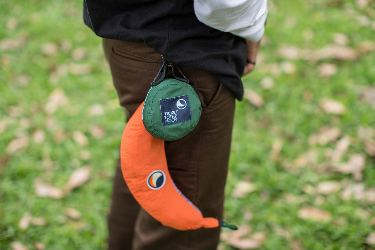 Lightest Straps (2-Pack) packed in a small green pouch clipped to a belt loop next to an orange stuff sack