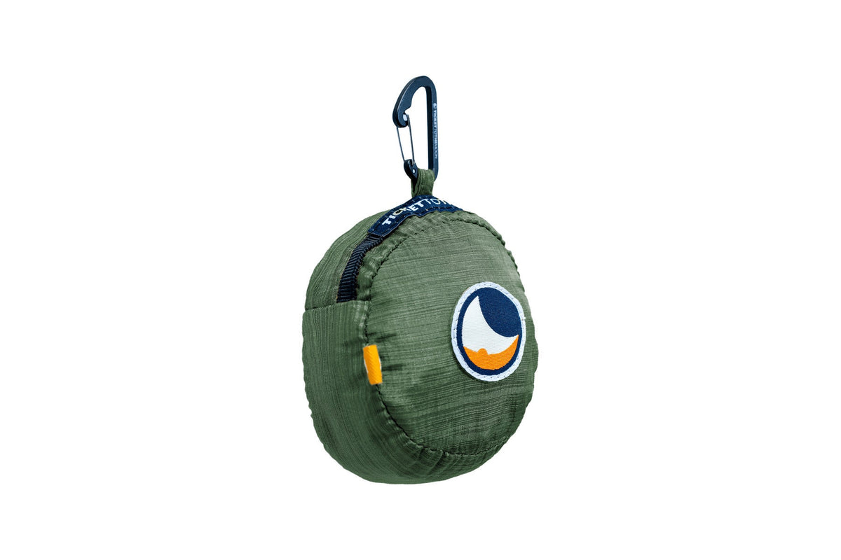 Moon Bag Large (Premium) folded into its Sage Green pouch with a carabiner