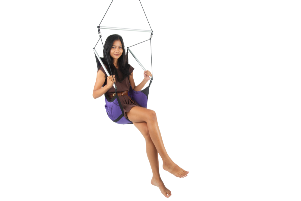 Woman sitting barefoot in a Moon Chair (Custom) in purple, holding the spreader bars