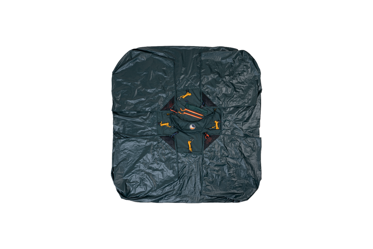 Moon Tarp folded flat into a square with its built-in pouch and orange guylines