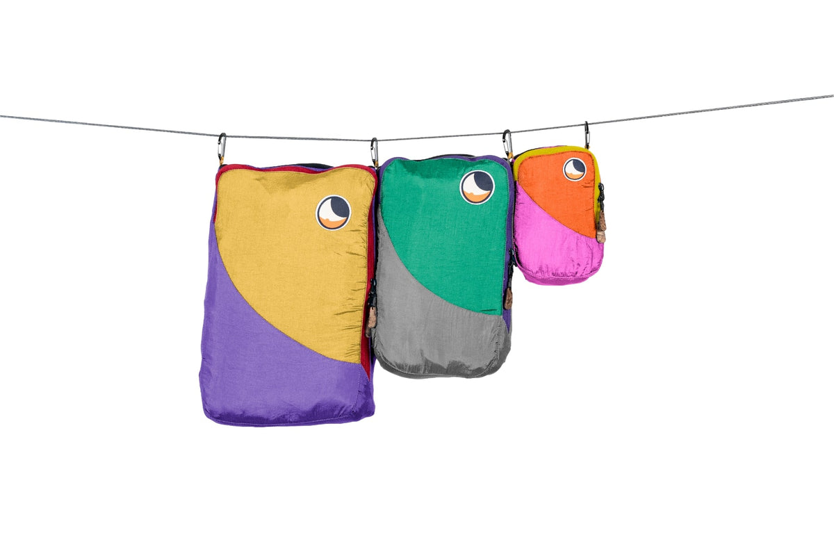 Travel Cube Set in multicolour: yellow and purple, green and grey, orange and pink cubes hanging from a line