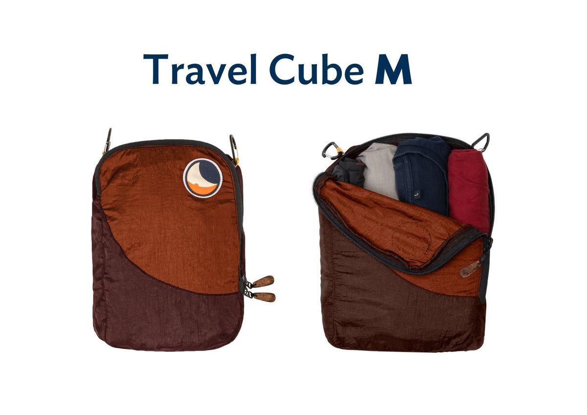Travel Cube Medium in burgundy and rust orange, shown closed and open with folded clothes inside