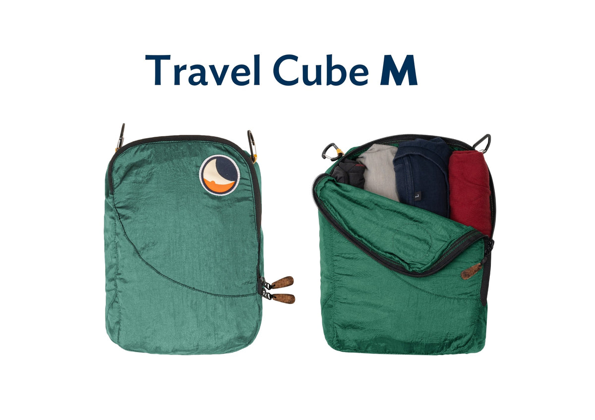 Travel Cube Medium in green, shown closed and open with folded clothes inside
