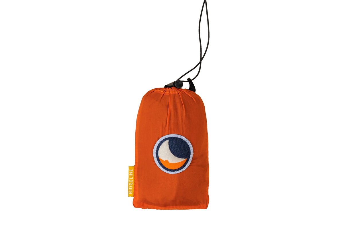 Ridgeline packed in its orange stuff sack with drawcord and logo patch
